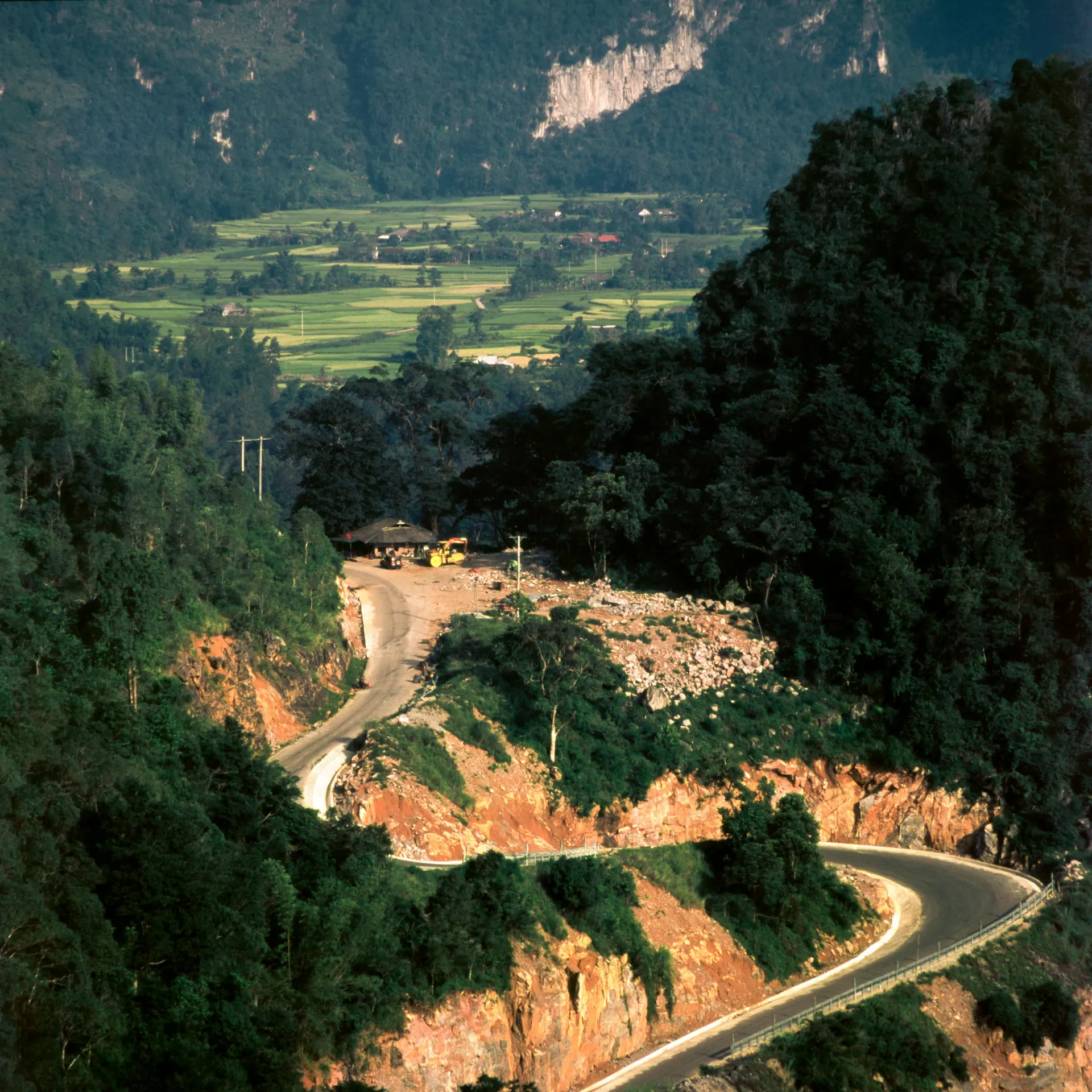 Open travel journal with map, postcards and tea in warm editorial light