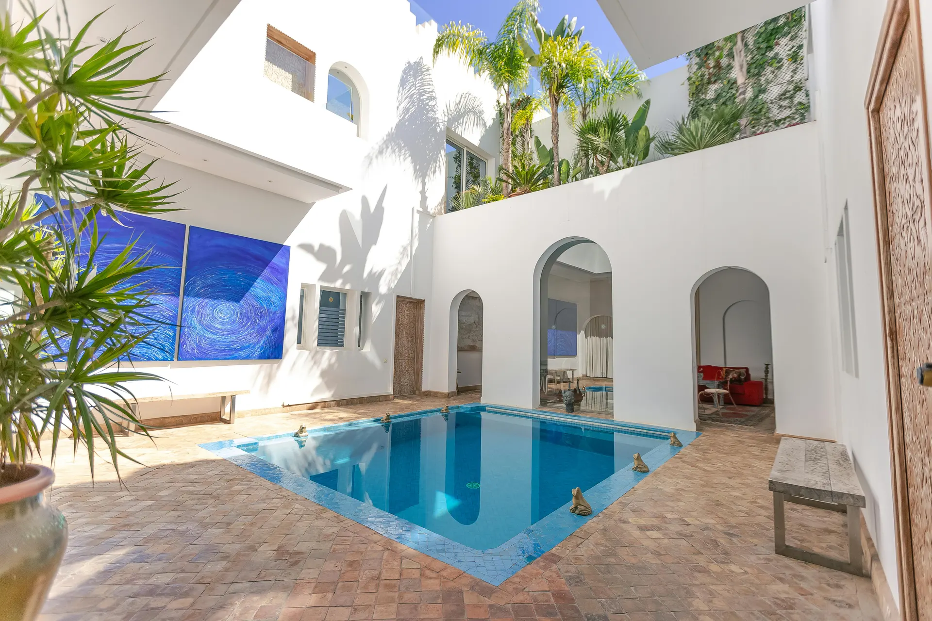 Boutique courtyard hotel with warm textures, pool and evening lantern glow