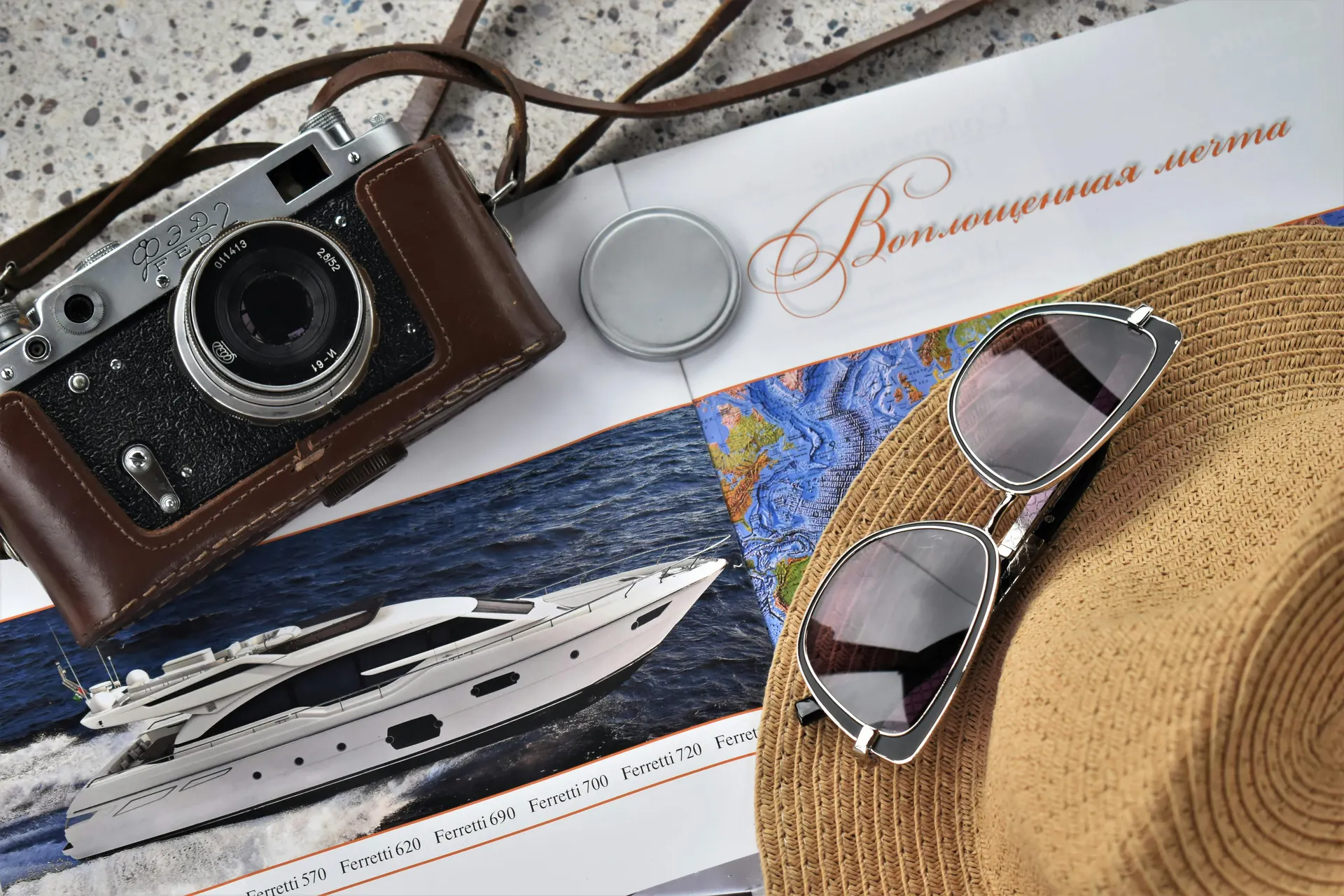 Packing flat lay with linen clothing, sunglasses and passport in warm natural light