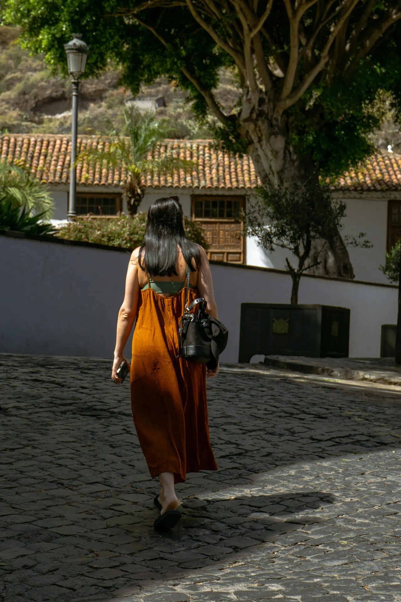 Traveller guided through a quiet historic street in warm evening light